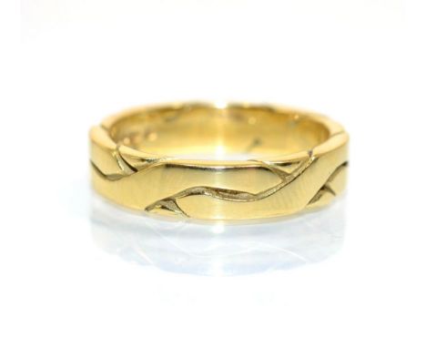 An 18 carat gold engraved band ring, finger size R.  7.8g