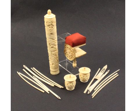 Four 19th Century Cantonese carved ivory pieces comprising a pin cushion clamp, 8cm, a pair of cotton barrels, and a cylinder