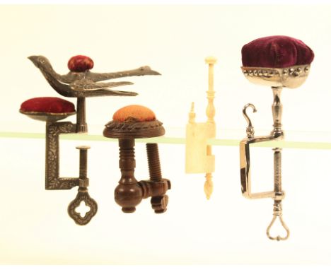 Four sewing clamps comprising a polished steel example with trough form pin cushion, the rectangular frame with hook, 14cm, a