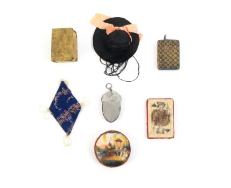 Seven pin cushions comprising a steel acorn form chatelaine example, 5cm, another in brass as a book, 4.5cm, a Spa work disc 