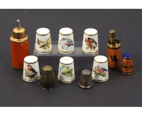 Nine thimbles and thimble compendiums comprising a thimble compendium in enamel with silhouette decoration, internal reel and