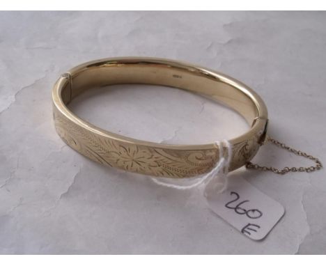 A modern 9ct chased top bangle     