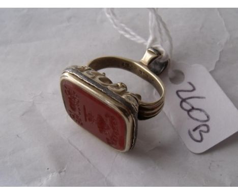 A gold cased antique fob seal mounted with an  interesting carved Cornelian intaglio of a sawn tree  and the words “Saw Throu