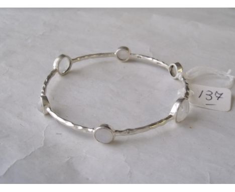 A silver bangle set with 6 faceted moonstones   