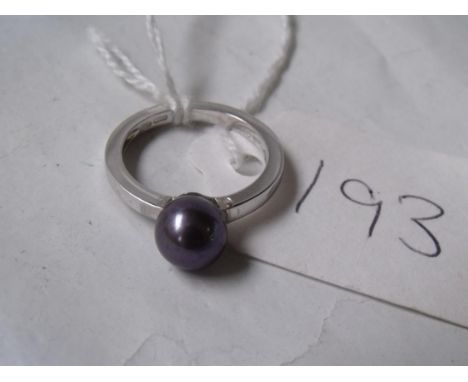 An unusual 18ct white gold ring set with a single  black pearl with signature to shank size 'P' 4.8g   