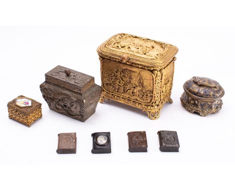 A collection of metal boxes, late 19th and 20th century; comprising a gilt example with figural relief scenes to top, front, 