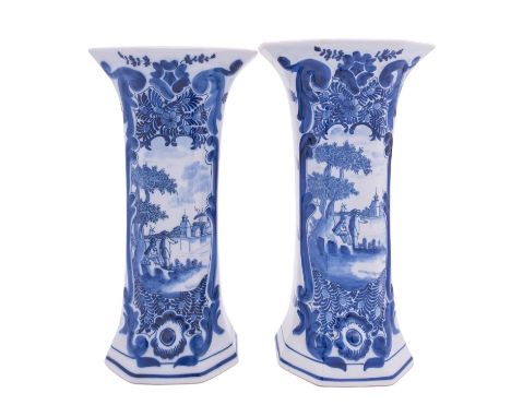 A garniture of five Dutch delftware vases, three of flattened baluster form with domed covers with lion knops with covers wit