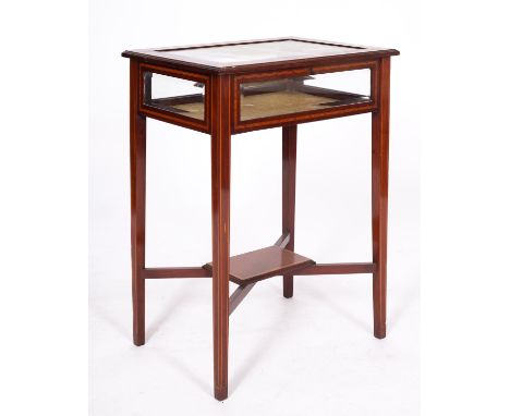 An Edwardian mahogany and line inlaid bijouterie table, early 20th century; the crossbanded and glazed top and sides upon squ