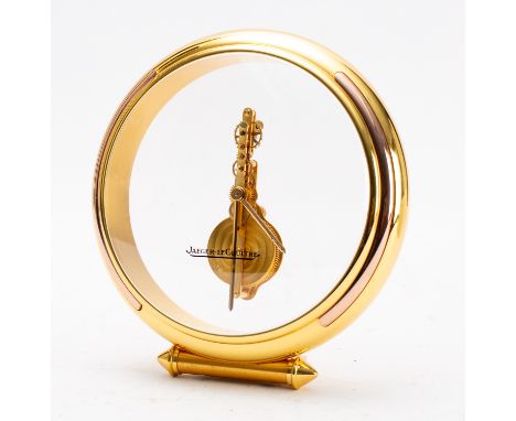 Jaeger-LeCoultre a circular gilt-brass and perspex mantel clock having an eight-day duration jeweled skeletonised in-line mov