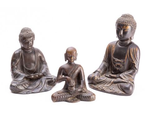 A Tibetan bronze Buddha, a similar bronzed metal Buddha and a small Indian bronze figure of a Buddhist monk 20th century, 20/