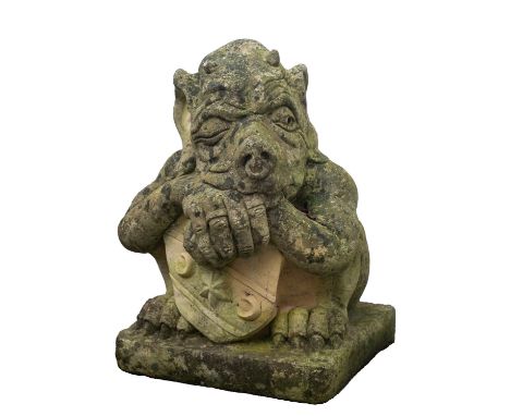 A stone composition garden model of a grotesque, probably by Haddonstone, modern; the figure portrayed as crouched over an ar