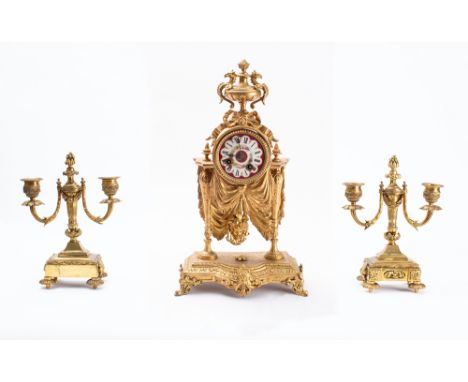 A gilt-metal and porcelain French Victorian mantel clock garniture the eight-day duration movement striking the hours and hal