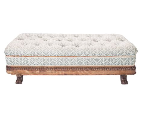 A  Victorian rosewood ottoman window seat, of angled design, having an upholstered stuff over button down hinged seat in foli