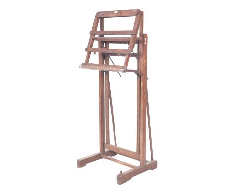 An oak studio easel by Clifford Milburn & Co, early 20th century; with ratchet height adjustment and shelf pitch adjustment; 