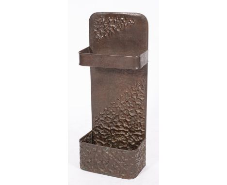 A repousse worked copper stick stand in Arts & Crafts style, circa 1900; the rectangular backplate and the box base with styl