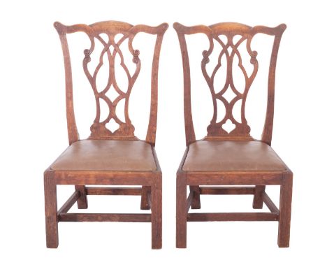 A pair of Scottish Edwardian oak 'Gossip Chairs', almost certainly by Wheeler of Arncroach, in the Chippendale manner, the ba