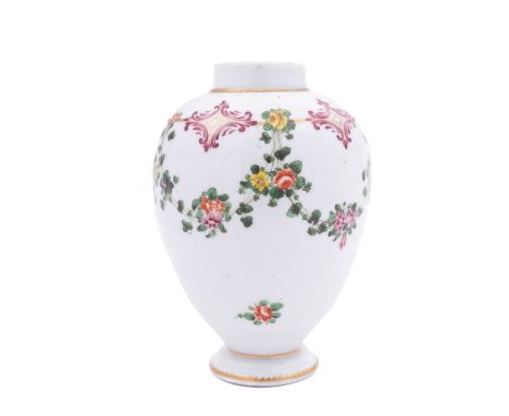 A Champion's Bristol tea canister of ovoid form painted with a continuous floral garland suspended from a gilt line with puce