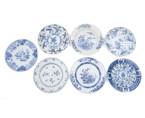 Seven Chinese porcelain plates, of circular form, each painted in blue with flowers, foliage or garden scenes, largest 23cm d