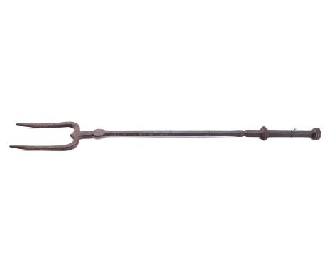 A steel log fork in 17th century taste, early 20th century; the knopped square section handle and square section shaft with p