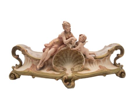Royal Dux Bohemia, a porcelain two handled jardiniere in the form of a boat with shell and scroll decoration and surmounted b