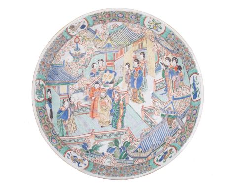 A Chinese famille verte charger, Kangxi finely enamelled with a court scene with figures on the terrace of a large pavilion w