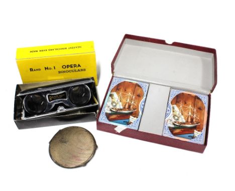 A silver powder compact, Rand No.1 Opera  Binoculars with original box and a pack of unopened vintage playing cards (3)
