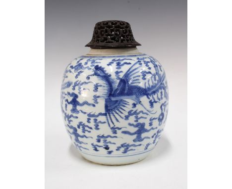 Chinese blue and white dragon and phoenix ginger jar, bearing double ring mark to base, 21cm, with an associated pierced wood