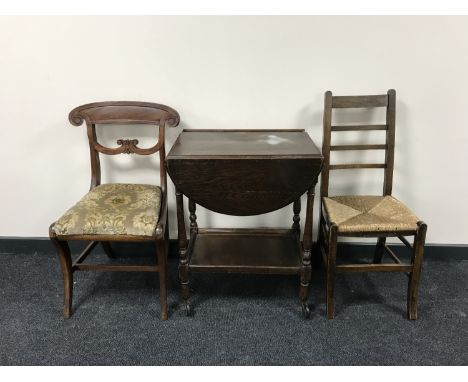 An oak dropleaf two tier tea trolley together with an oak ladder back rush seated bedroom chair and a Victorian mahogany dini