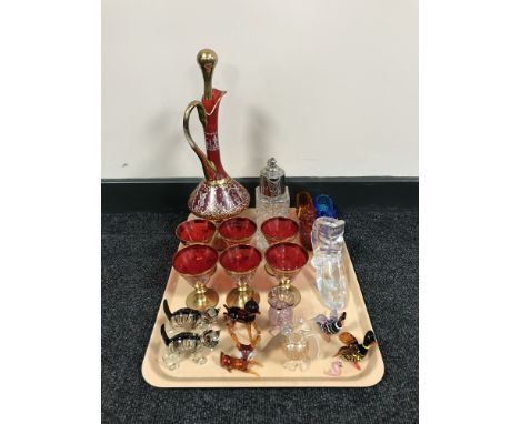 A tray of glassware including deer, duck and cat ornaments, red glass and gilt liqueur decanter and glasses, glass shoes etc 