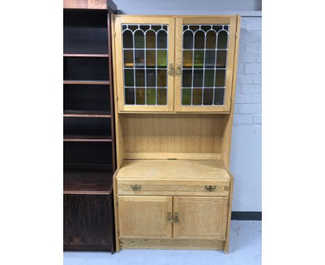 A blonde oak leaded glass door cabinet fitted cupboards and shelf below 