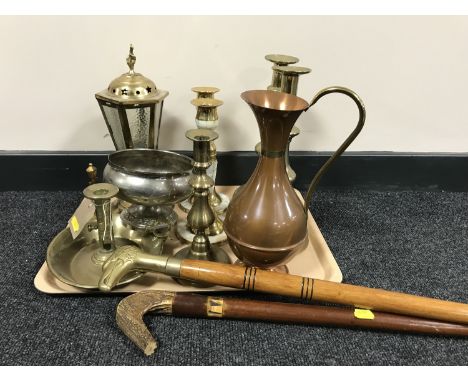 A tray of brass candlesticks, copper jug, brass lantern table lamp, two walking sticks 