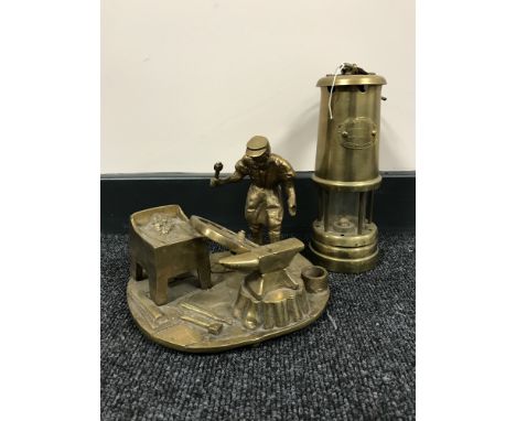 A brass Lime Light miner's lamp and a brass ornament of a wheel right 