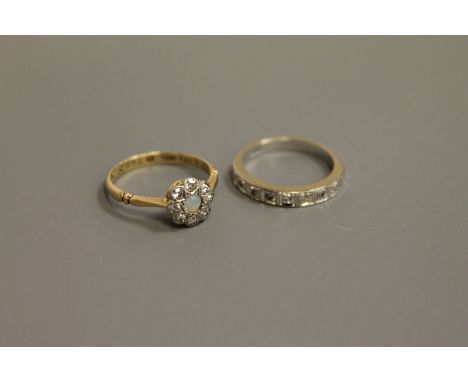 A white gold diamond half eternity ring and an 18ct gold diamond and opal cluster ring