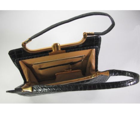 LADIES POST WAR BLACK STAINED CROCODILE SKIN HANDBAG with two strap handles and gilt metal mounts, of conventional style, 11 