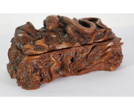 EARLY 20TH CENTURY CONTINENTAL CARVED WALNUTWOOD RUSTIC BOX in the form of a fallen tree trunk the hinged lid surrounded by a