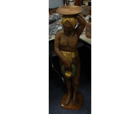 A PERHAPS RARE CARVED OAK NAKED MALE FIGURE,  standing holding aloft a shallow fish and with a laurel garland in his right ha