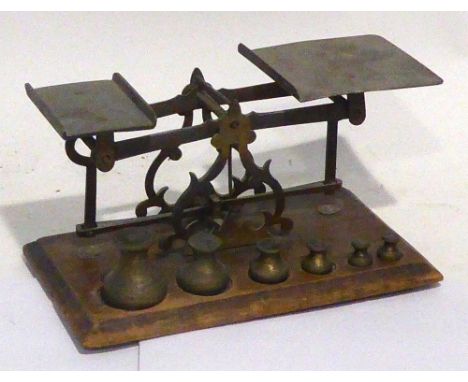 EARLY 20TH CENTURY BRASS LETTER SCALE with six graduated weights, on wooden plinth base