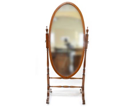 Cheval Mirror Second quarter 20th-century walnut framed cheval mirror, oval glass supported on two turned columns, trestle ba