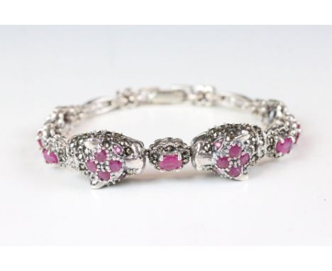 A substantial silver marcasite and ruby line bracelet. 