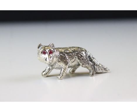 A silver figure of a fox with ruby eyes. 