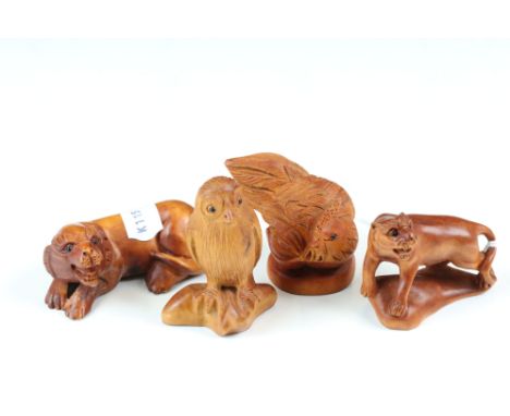 Four Japanese carved wooden animal netsuke to include an owl, rooster and two lions each with incised character marks to the 