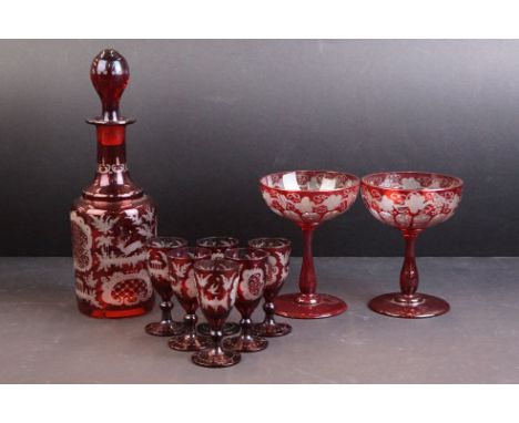 Bohemian ruby flash glass sherry decanter together with six glasses and two wine glasses. The decanter being acid etched with