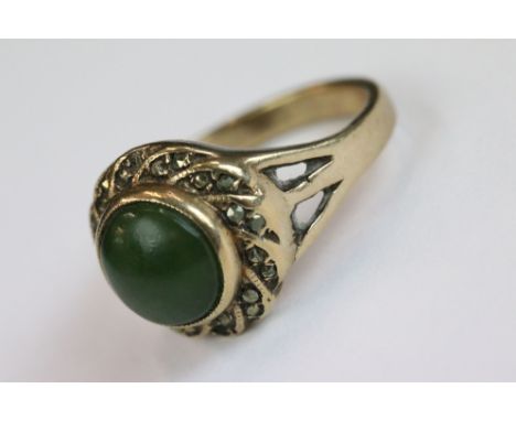 A vintage 9ct gold ring set with Jade cabochon centre stone surrounded with marcasite. 