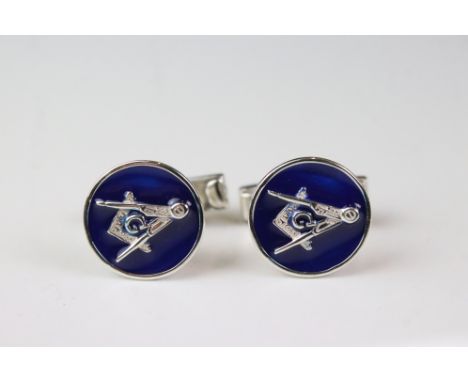 A pair of silver and enamel masonic cufflinks. 