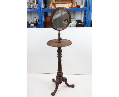 19th century Mahogany Gentleman's Shaving Stand with hinged adjustable circular mirror over a circular shelf, raised on turne