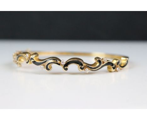 A 14ct yellow gold diamond and enamel set bangle 