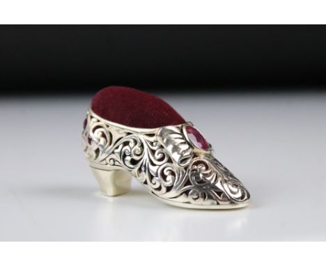 A silver plated shoe style pincushion with ruby cabochons. 