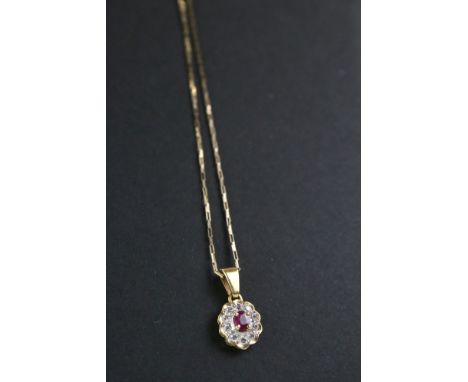 A 9ct yellow gold ruby and diamond pendant necklace. 