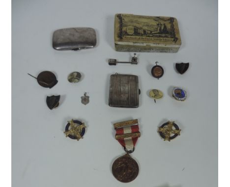 An Emergency Medal, with ribbon and clasp, in box; a small tin Cigarette Box of various Irish & other badges, a small Birming