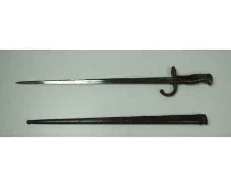 A good 19th Century French Gras Bayonet, the handle with wooden grip and brass pommel, blade 52.5cms (20 1/2") long, inscribe